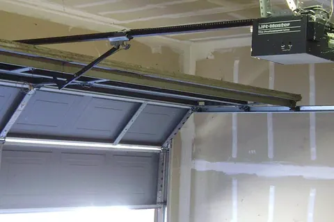 Garage door with overhead opener and track