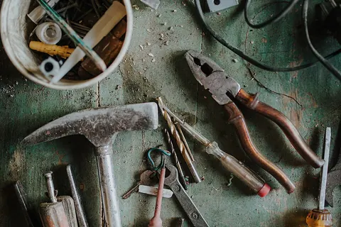 Pliers and other hand tools on a workbench