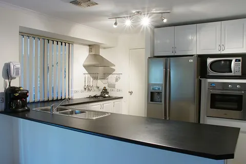 Home kitchen with cabinets and appliances