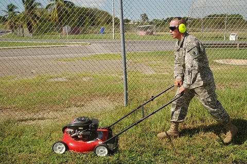 Worker mowing a lawn